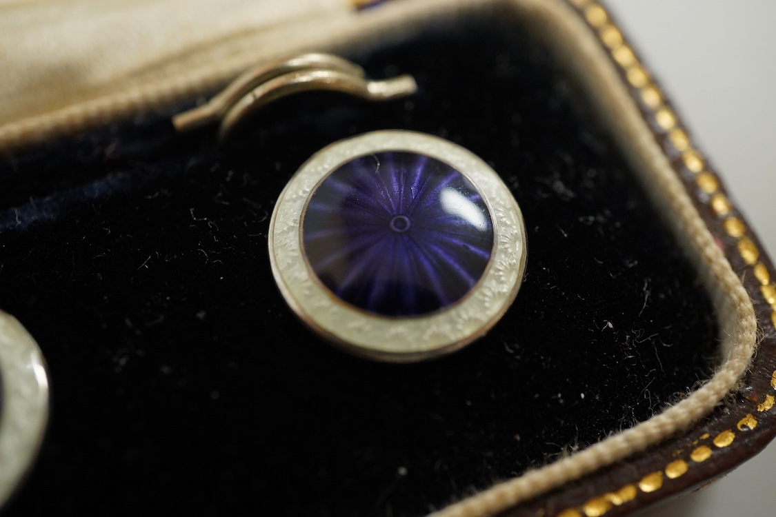 A set of four silver and two colour enamel buttons, by Lawson, Ward & Gammage Ltd, Birmingham, 1910, diameter 12mm, in original gilt tooled leather case by Rowell & Son Ltd of Oxford.